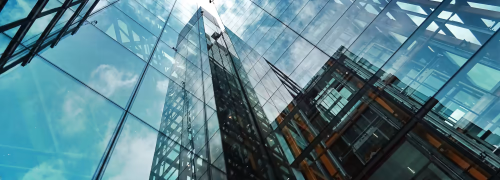 A view up the side of a glass-faced city building
