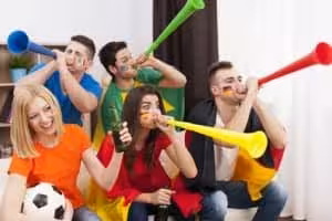 Soccer fans blowing vuvuzela