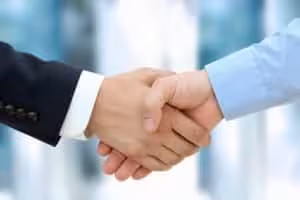 Close-up image of a firm handshake between two colleagues